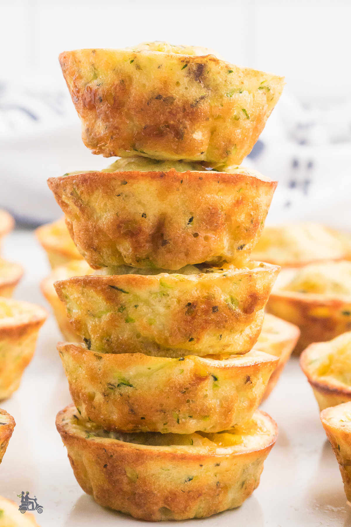 Miniature savory appetizer muffins piled five high in a stack. 