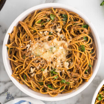 A white bowl filled with French Onion Spaghetti made with a viral TikTok recipe.