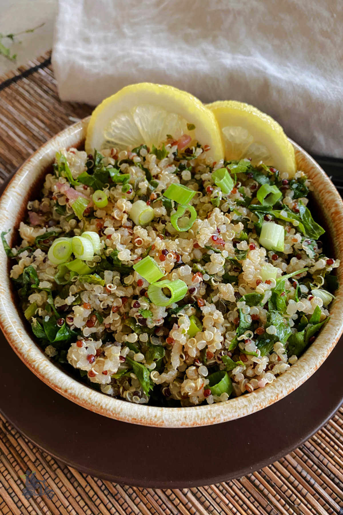A bowl filled with lemon and herb quinoa with spinach recipe. 