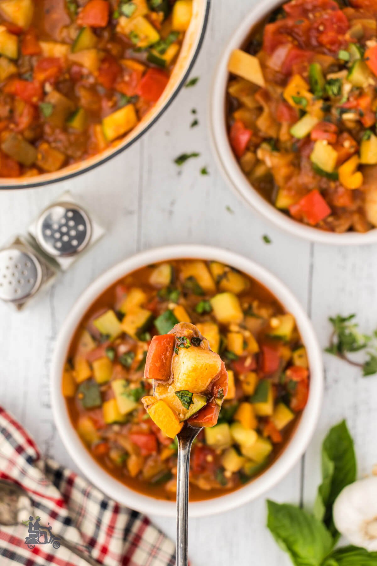 Spoonful of Italian ratatouille featuring chunks of cooked vegetables. 