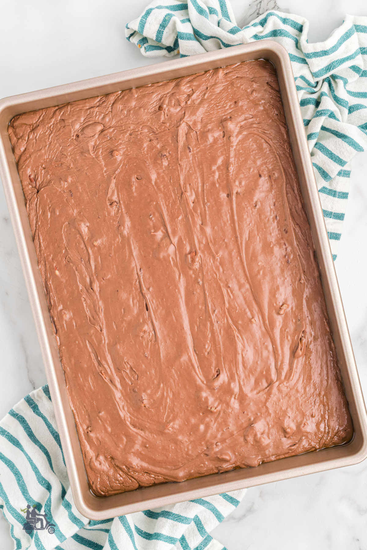 Creamy Chocolate Fudge getting set in a rectangular pan before the candy can be cut into portions. 
