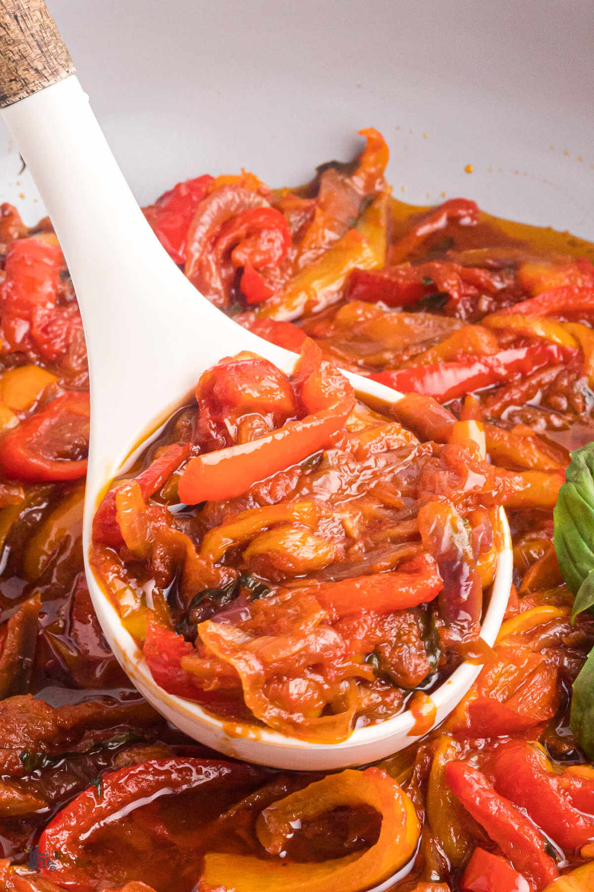 Closeup of the tender bell peppers stewed in olive oil, tomato, and garlic. 