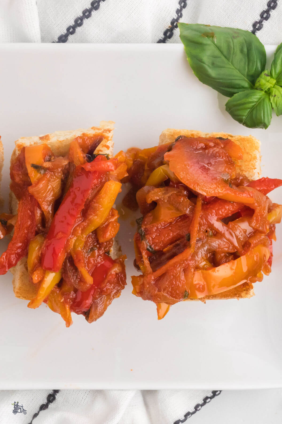 Sweet bell peppers stewed in olive oil and spread on toasted baguette slices for an antipasto. 