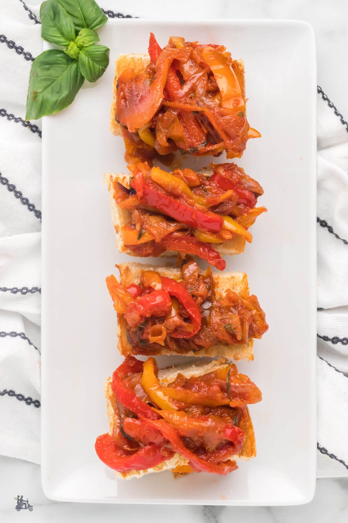 Italian sauteed colored peppers served on top of toasted bread slices for a bruschetta appetizer. 
