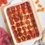 Pizza casserole made with tater tots and topped with pepperoni slices.
