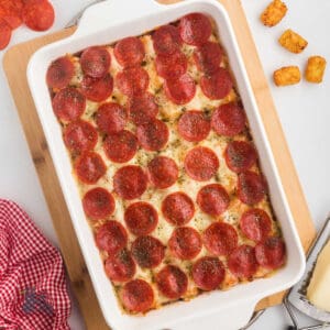 Pizza casserole made with tater tots and topped with pepperoni slices.