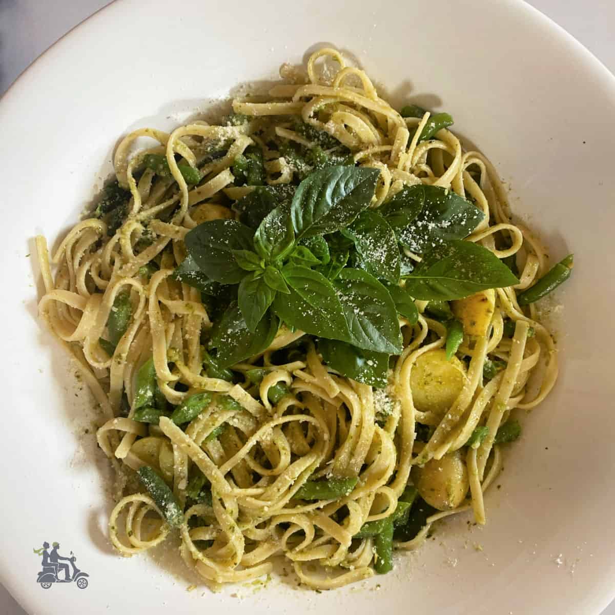 Pasta al Genovese Pesto in a white bowl made with green beans and Yukon Gold potatoes.