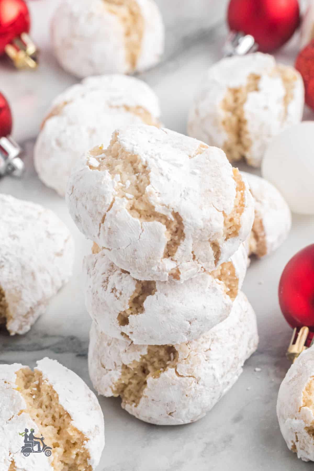 Gluten-Free Italian Almond cookies rolled in powdered sugar and stacked on a table. 