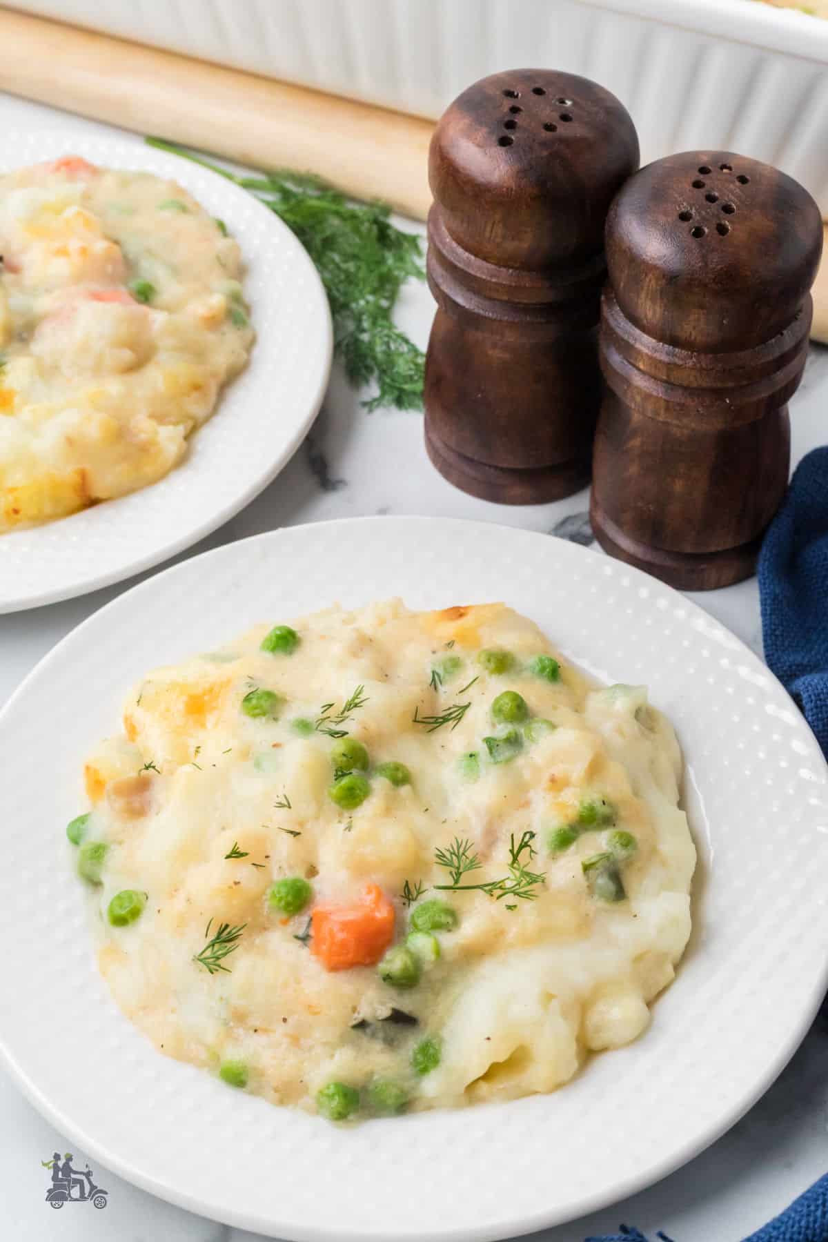 Closeup of the bowls of creamy Seafood Cottage Pie made with cod and topped with mashed potatoes. 