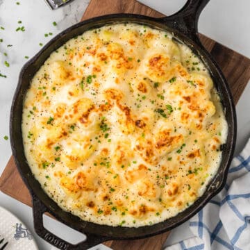 Creamy Parmesan Baked gnocchi in a rich cheesy sauce baked in a black cast iron skillet.