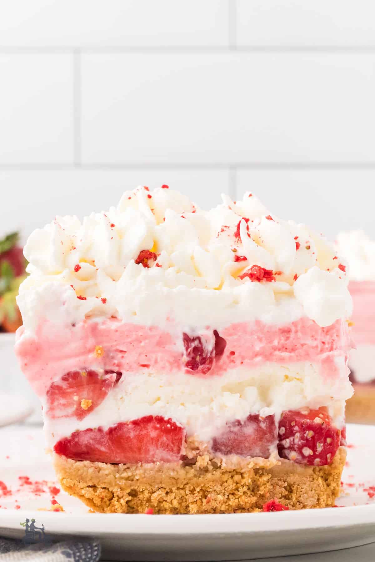 A fruity, no-bake dessert made with strawberries, whipped cream, jello, and cream cheese. 