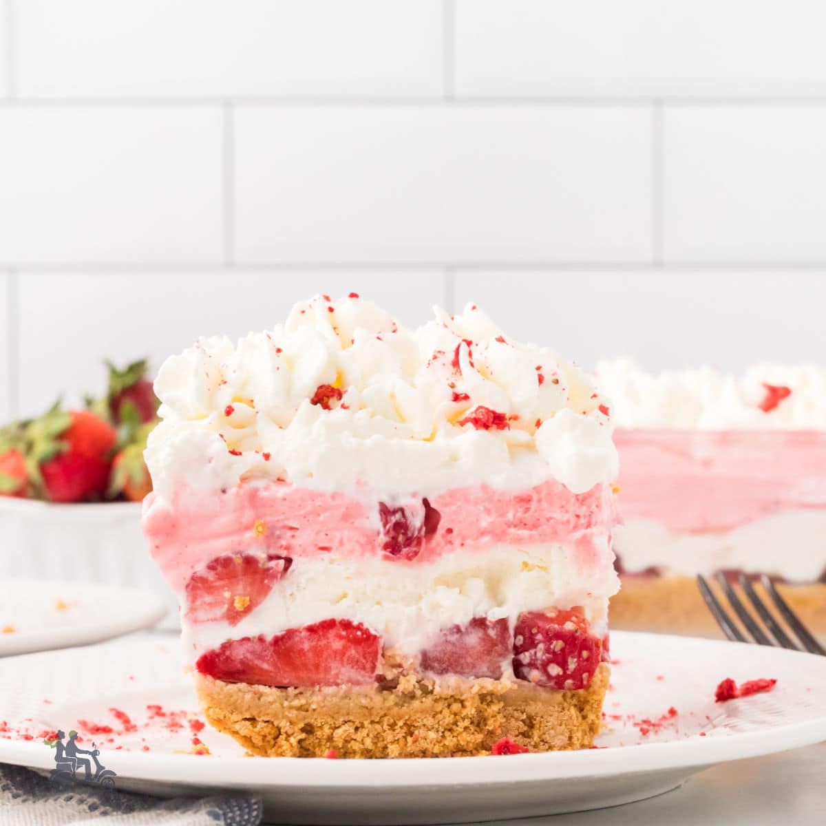 Strawberry Delight is a layered, no-bake dessert made with whipped cream, jello, and graham crackers.
