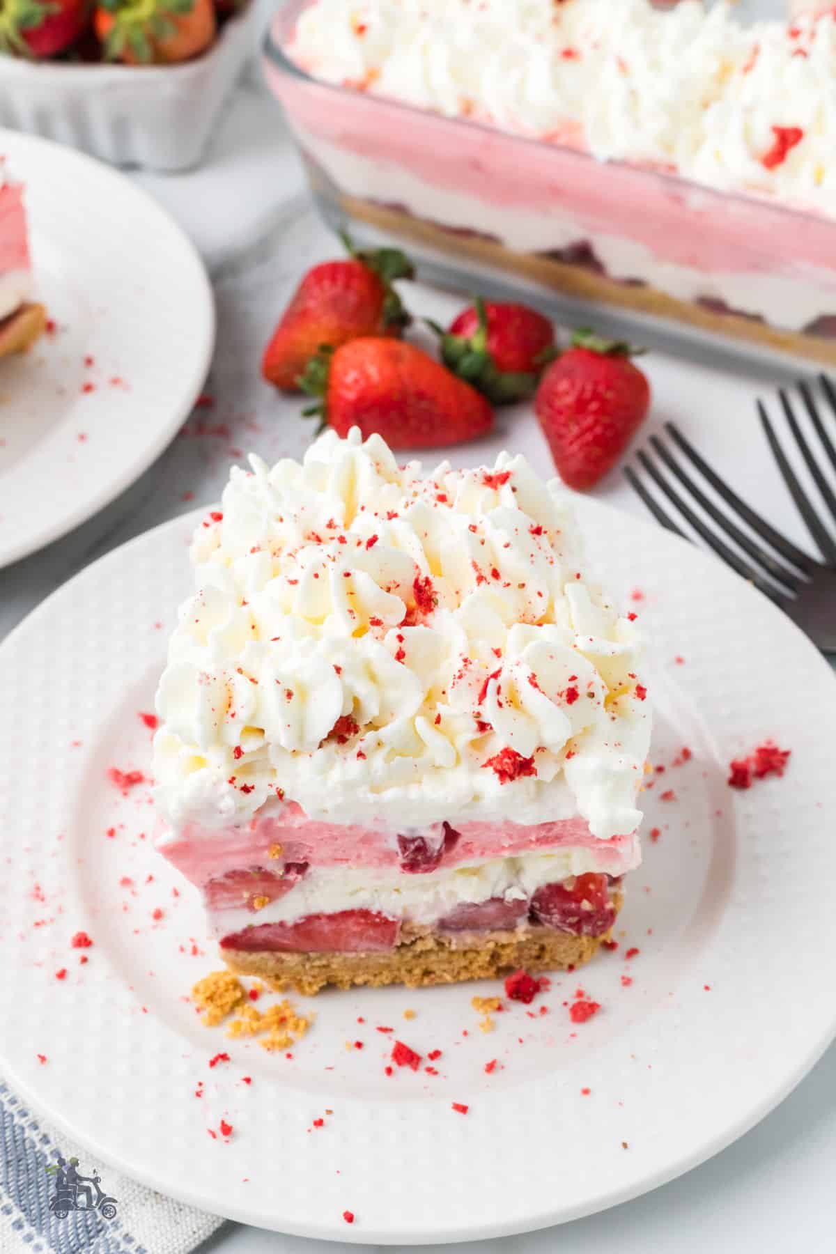 No bake strawberry dessert layered with jello, whipped cream, cream cheese, and a graham cracker crust. 