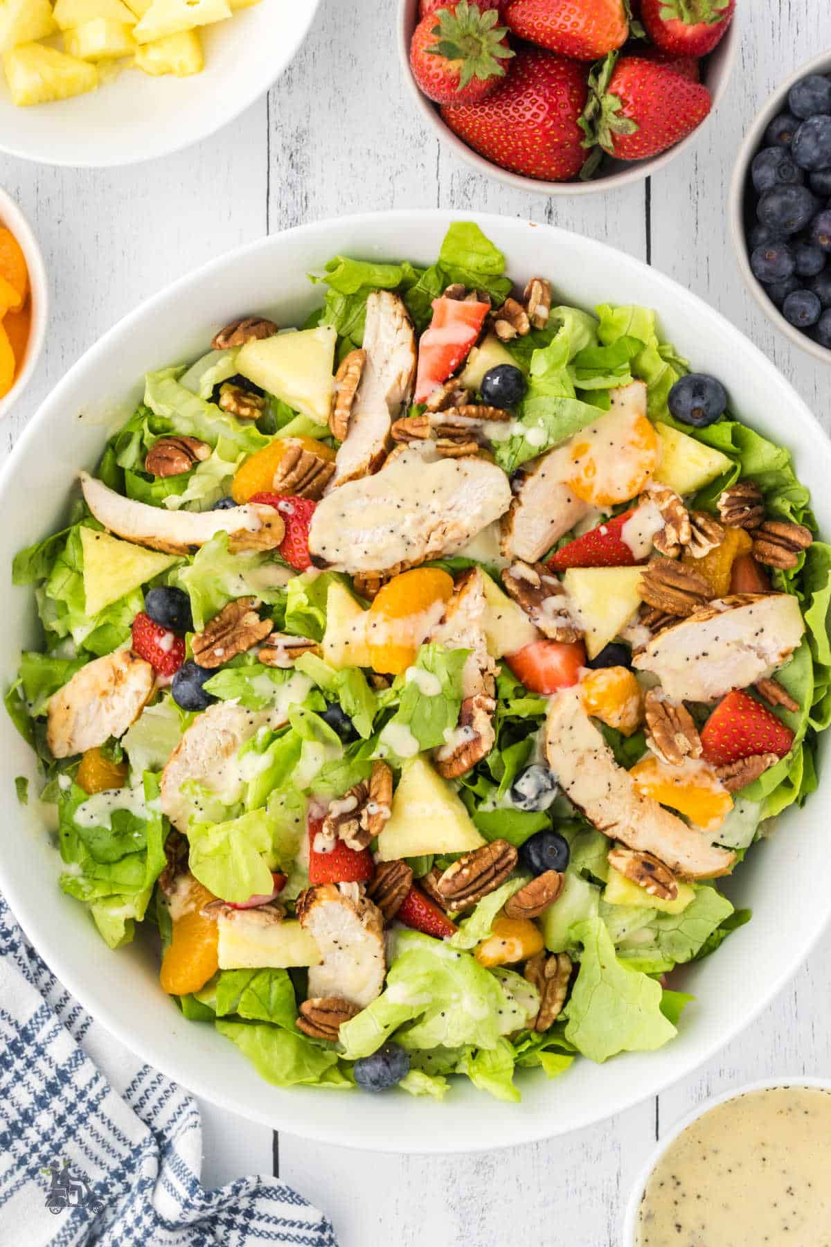 Butter leaf lettuce and strawberry combination salad with additional fruit, grilled chicken and poppyseed dressing. 