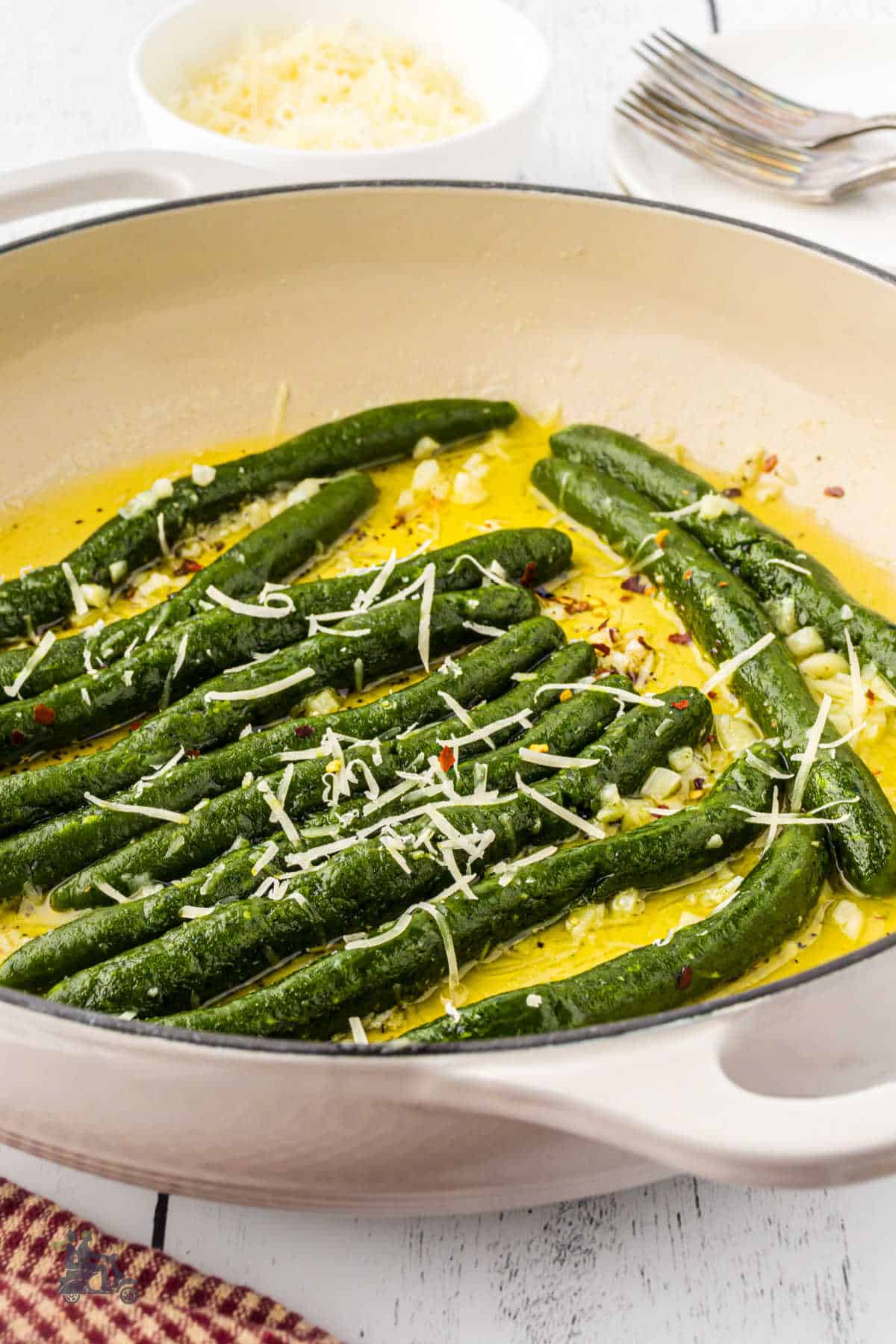 A Skillet contains the Spinach Pici in butter garlic sauce. 