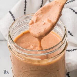 A glass jar filled with Russian salad dressing, sandwich spread, and dipping sauce.