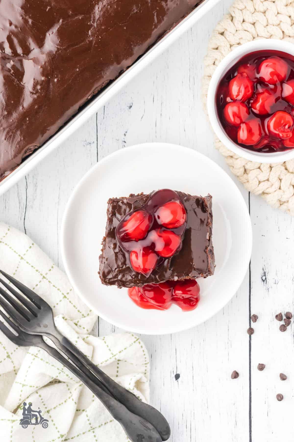 Overhead view of the chocolate cake with cherry pie filling on top. 