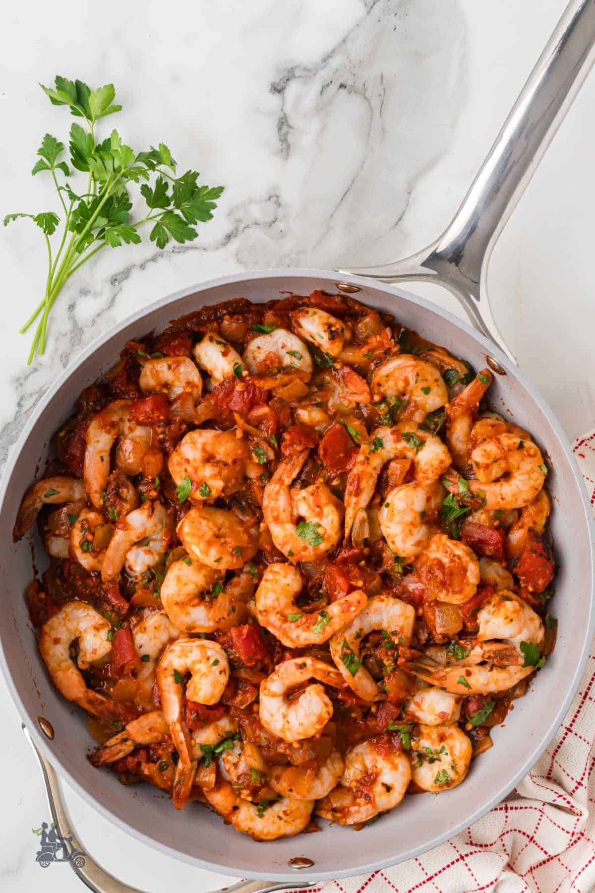 Italian shrimp is made in the fra diavolo style, a spicy tomato shrimp dish with red pepper flakes. 