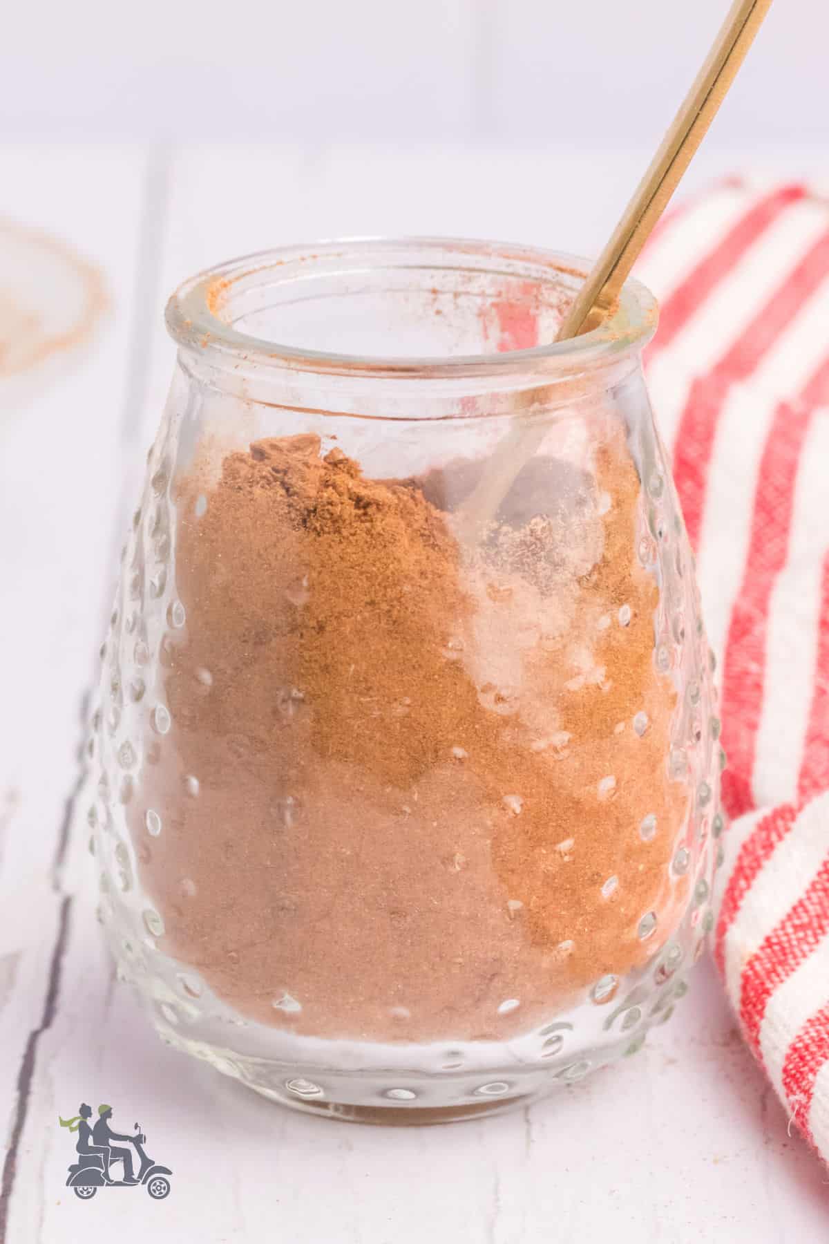 A glass jar filled with the apple pie spice recipe. 