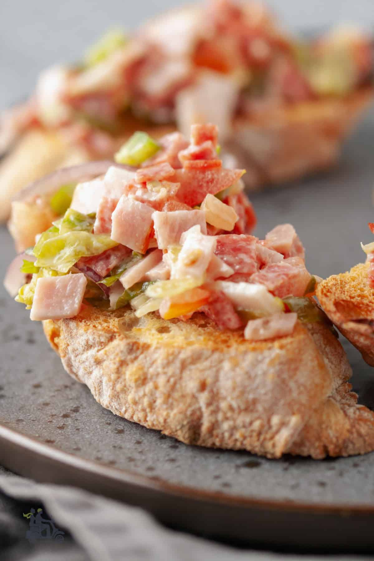 Italian chopped salad makes a topping for bruschetta appetizers.