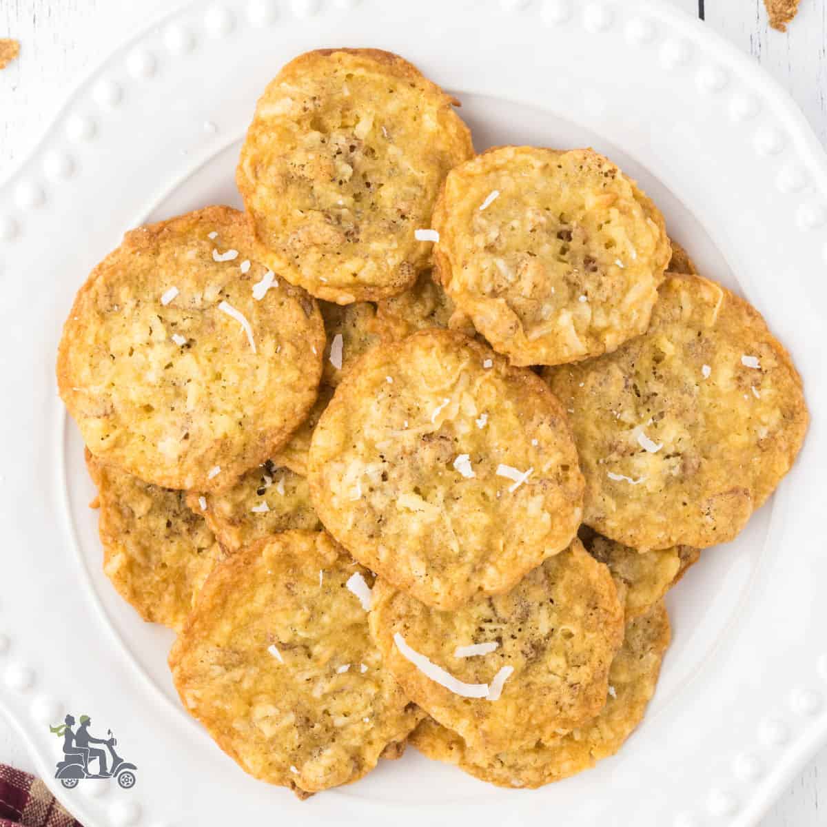 A white plate stacked with coconut cookies made with bran flakes.