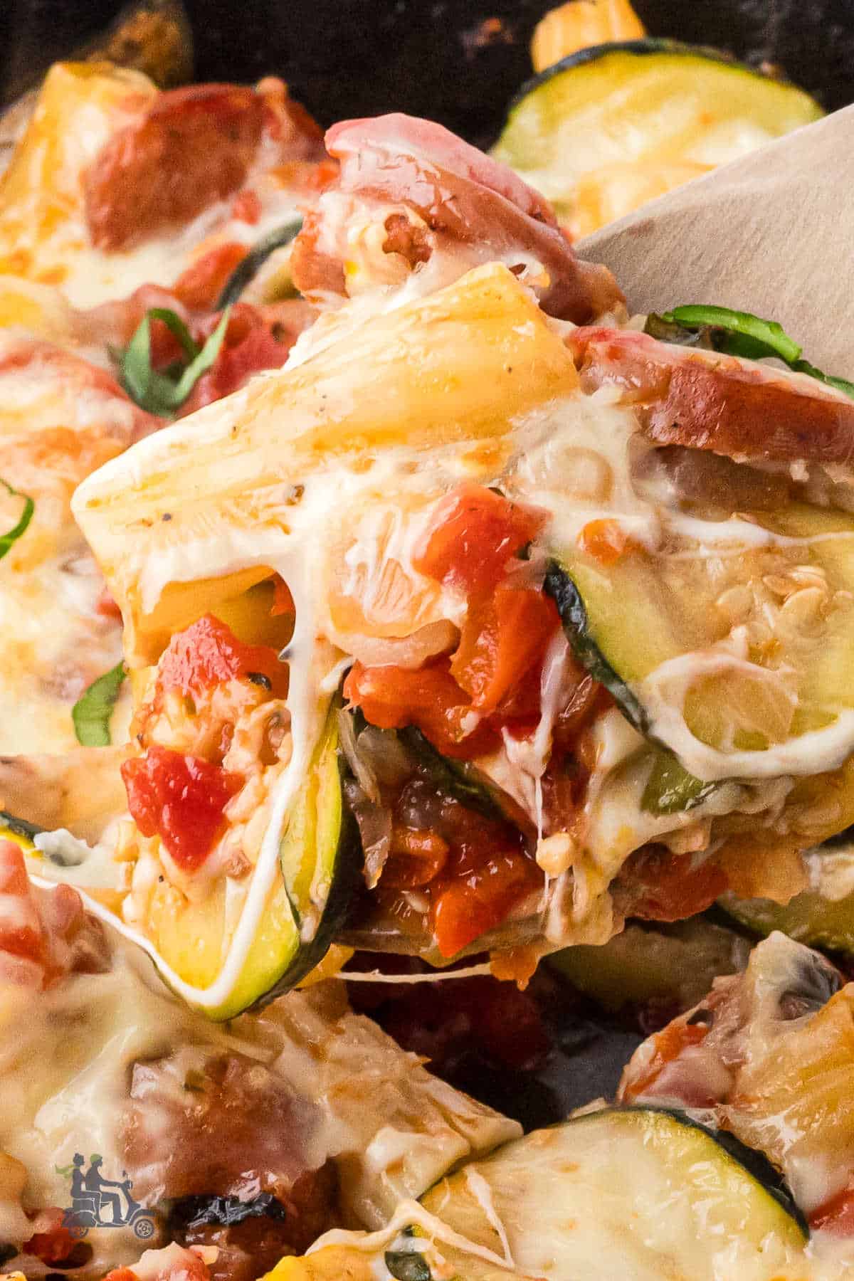 A wooden spoon grabs a helping of Summer Cheesy pasta. 