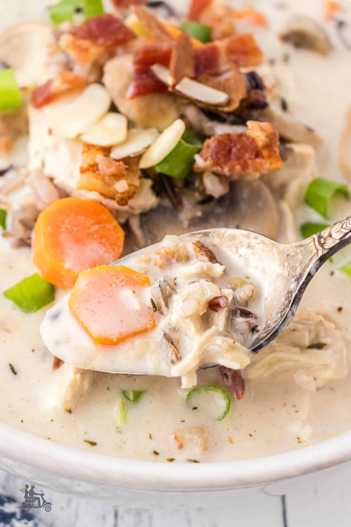 Close-up of a spoon holding a scoop of the Wild Rice Soup.