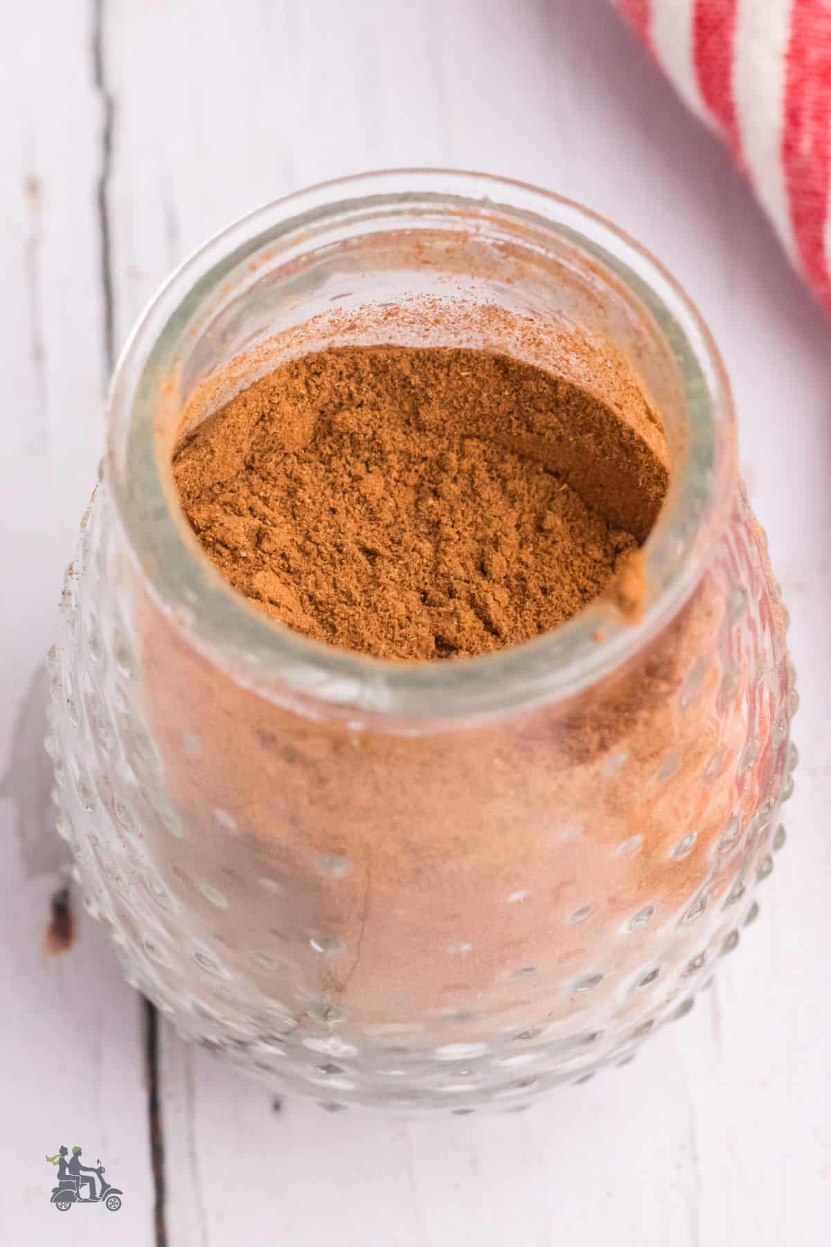 Cinnamon spice blend made for apple pie desserts in a glass jar ready for use. 