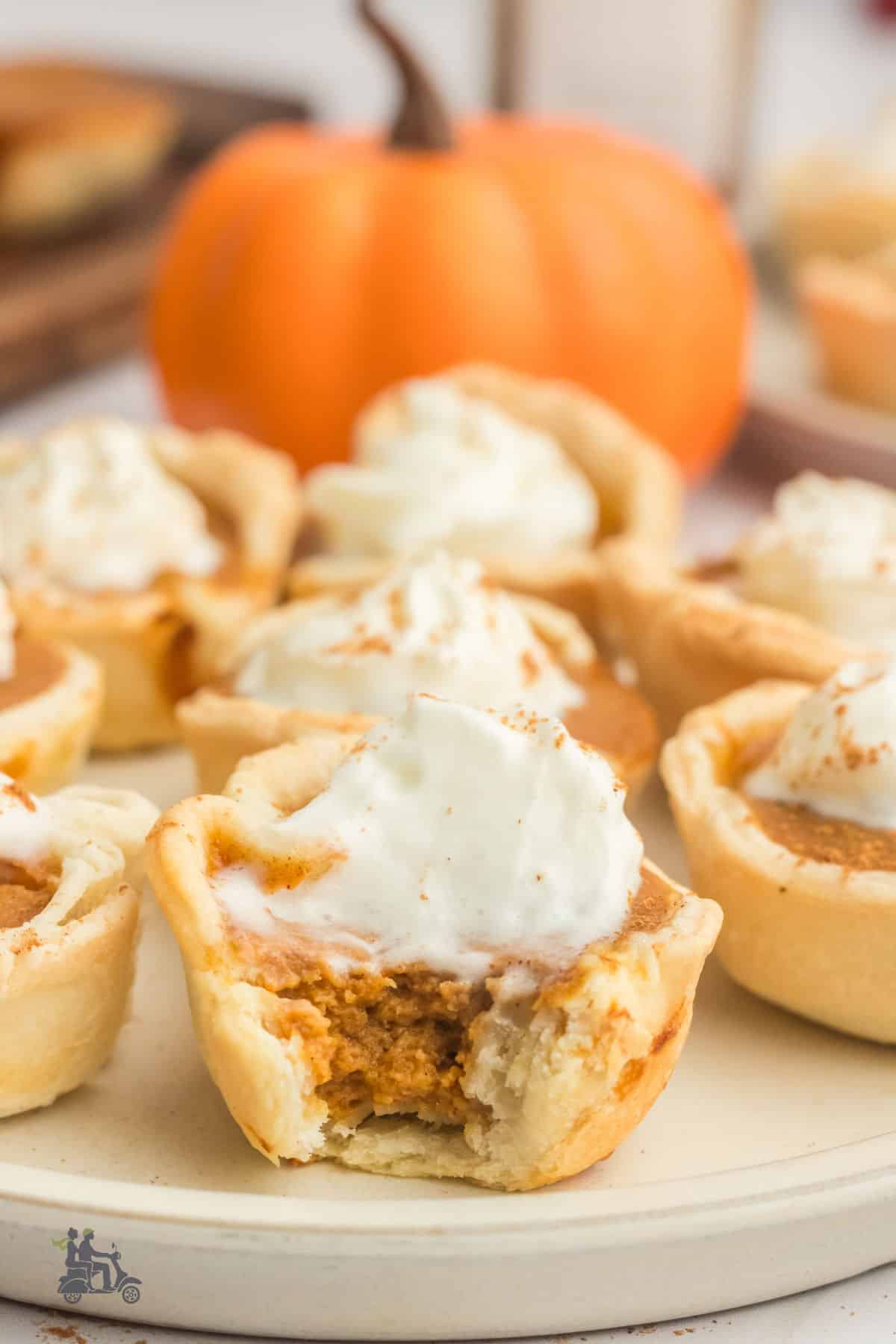 Side view of the miniature pumpkin pie with a forkful removed so the inside is visible. 