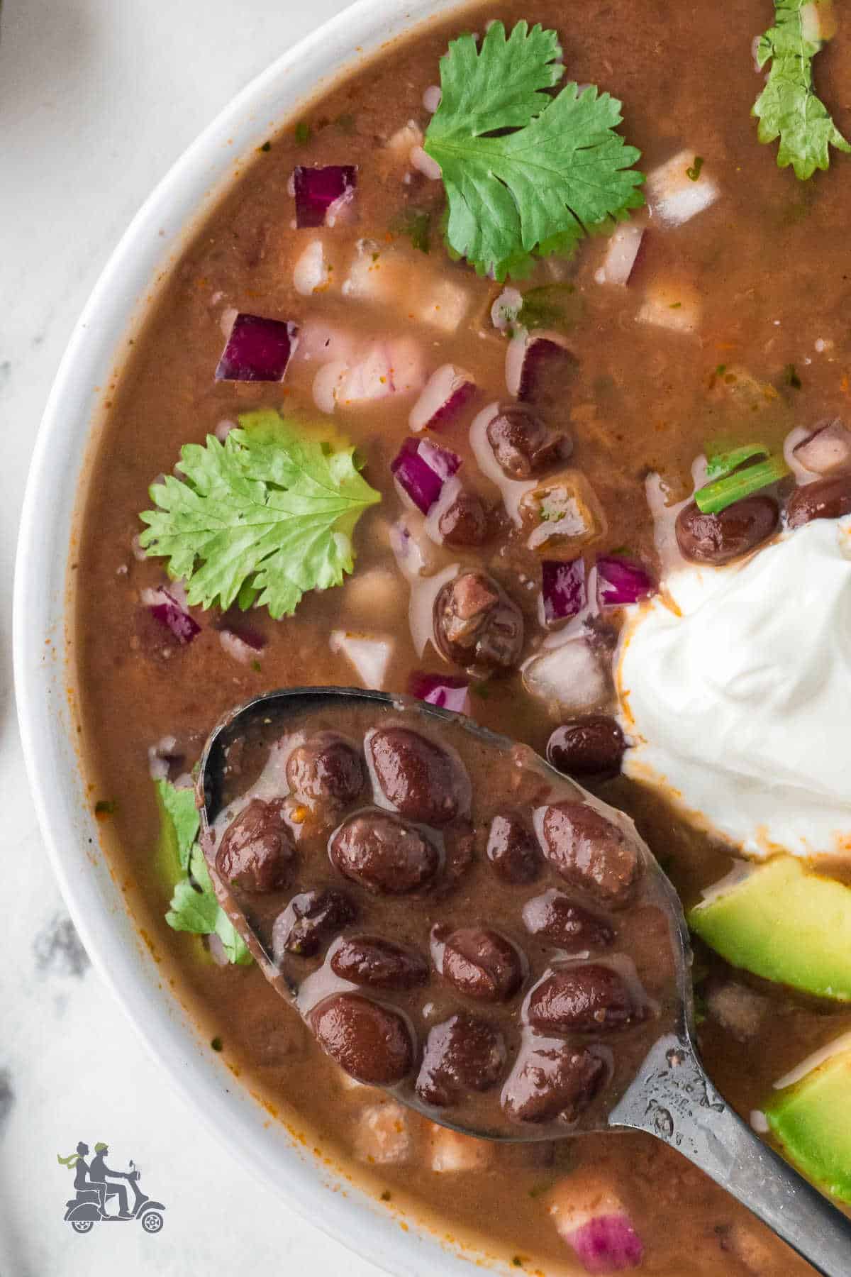 A vegetarian soup recipe is loaded with black beans and seasoned with cumin and chili powder. 