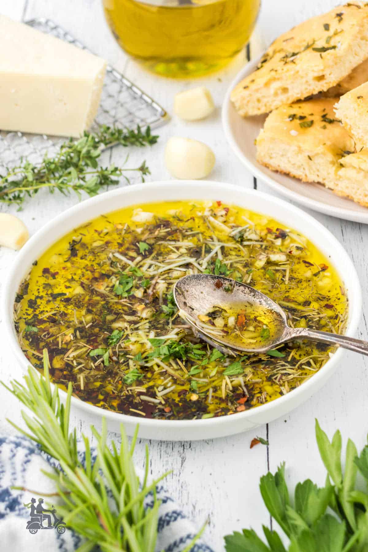 A shallow bowl combines garlic-flavored olive oil and herbs to make a bread dipping sauce. 