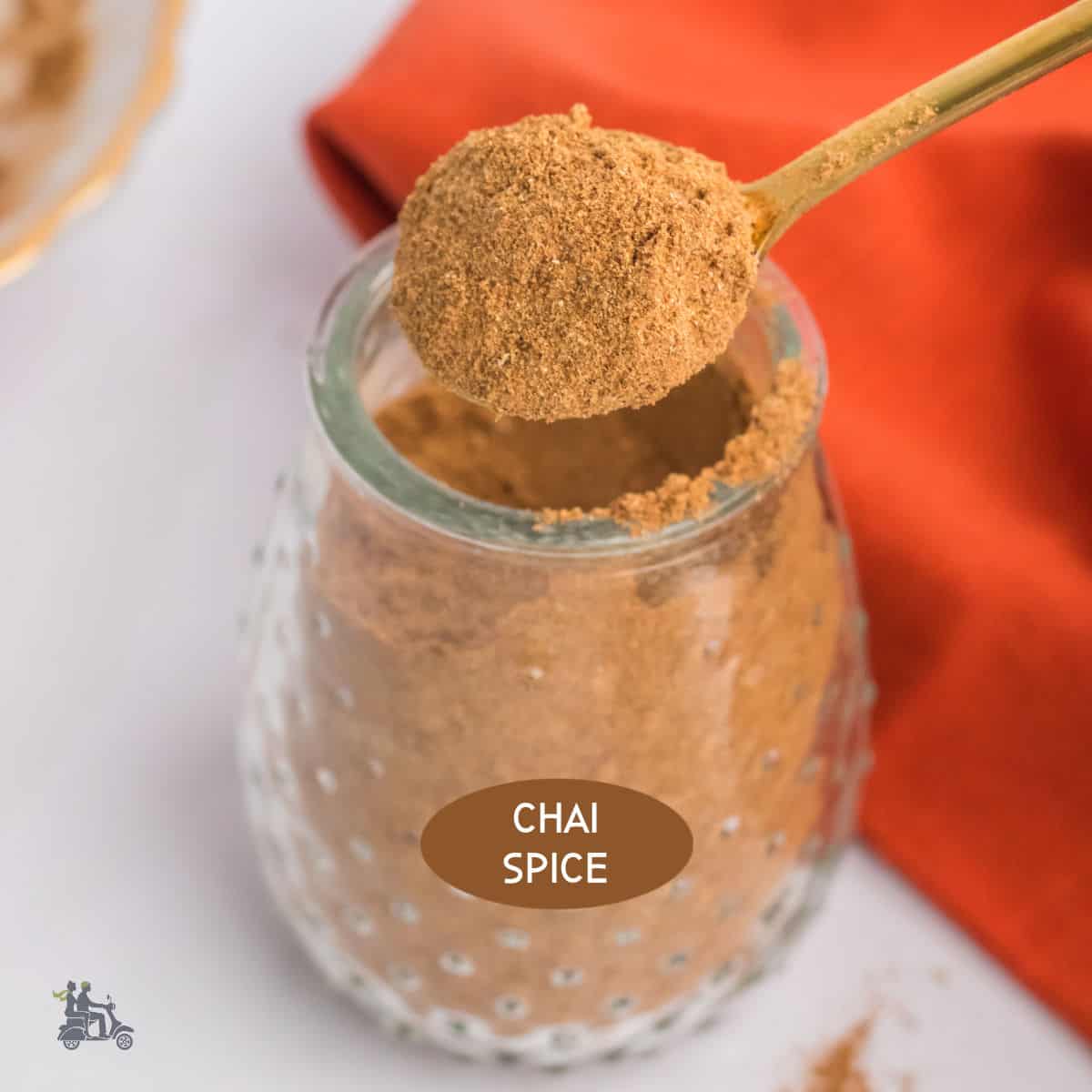 A glass jar filled with homemade Chai Spice Mix.