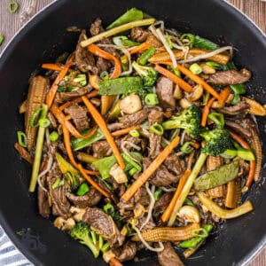 Beef chop suey in a black teflon-coated wok.
