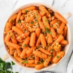 Marsala Glazed Carrots sprinkled with toasted hazelnuts and Italian parsley.
