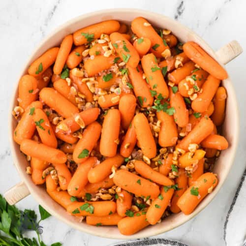 Marsala Glazed Carrots sprinkled with toasted hazelnuts and Italian parsley.