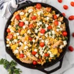 Mediterranean chicken thighs cooked with lemon orzo pasta in a one-skillet dish.