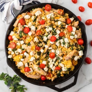 Mediterranean chicken thighs cooked with lemon orzo pasta in a one-skillet dish.