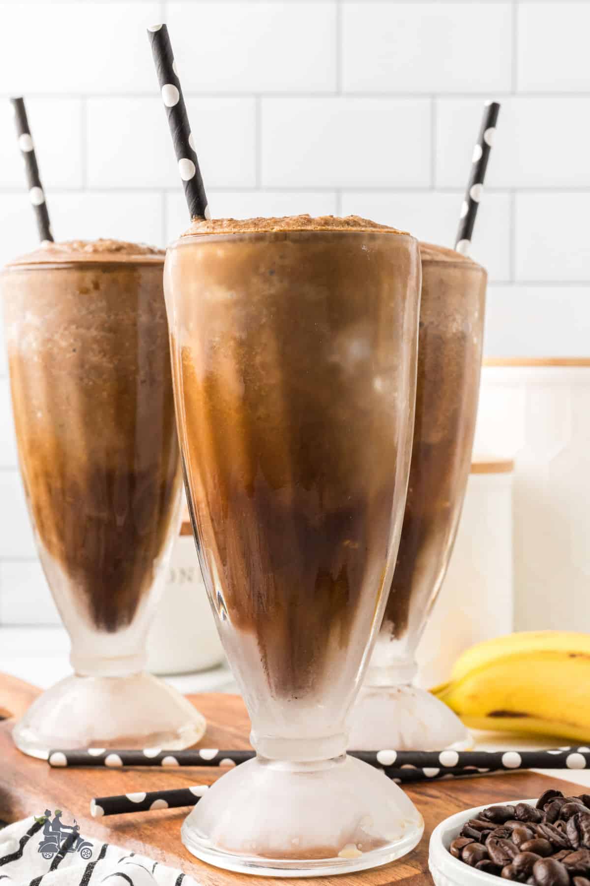 A healthy breakfast smoothie recipe made with bananas and espresso coffee in parfait glasses. 