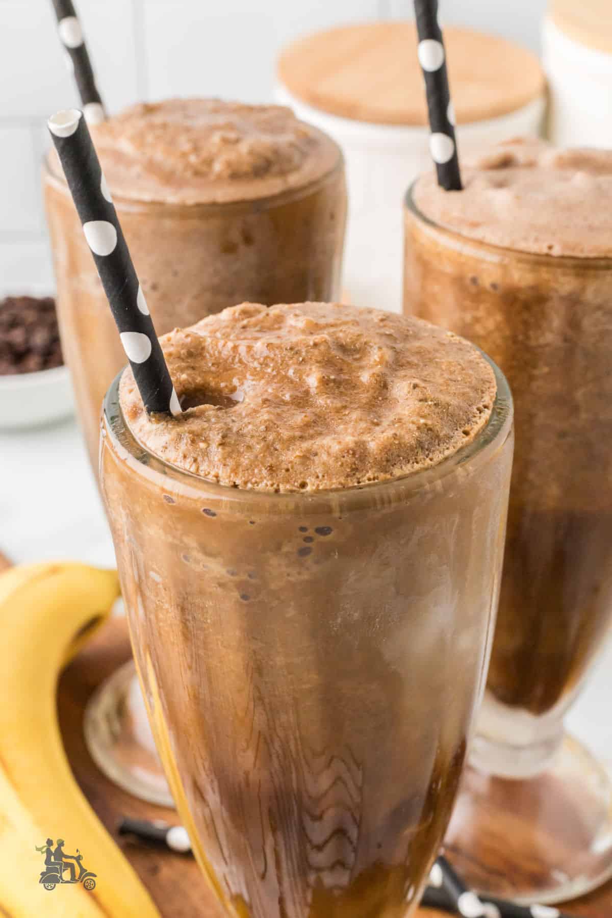 Creamy espresso banana smoothie with almond butter in parfait glasses. 