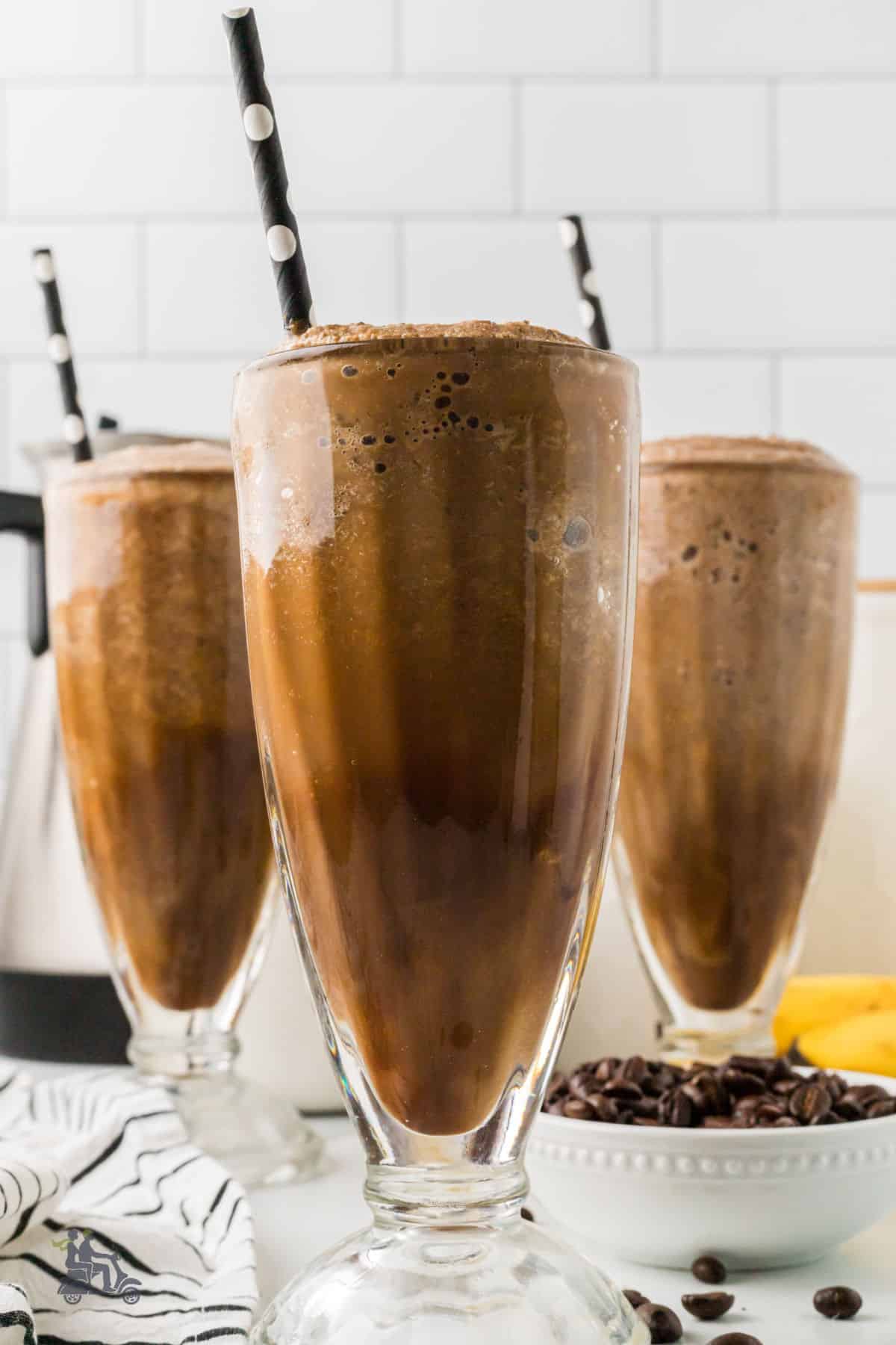 Breakfast smoothies in parfait glasses made from frozen bananas and espresso coffee. 