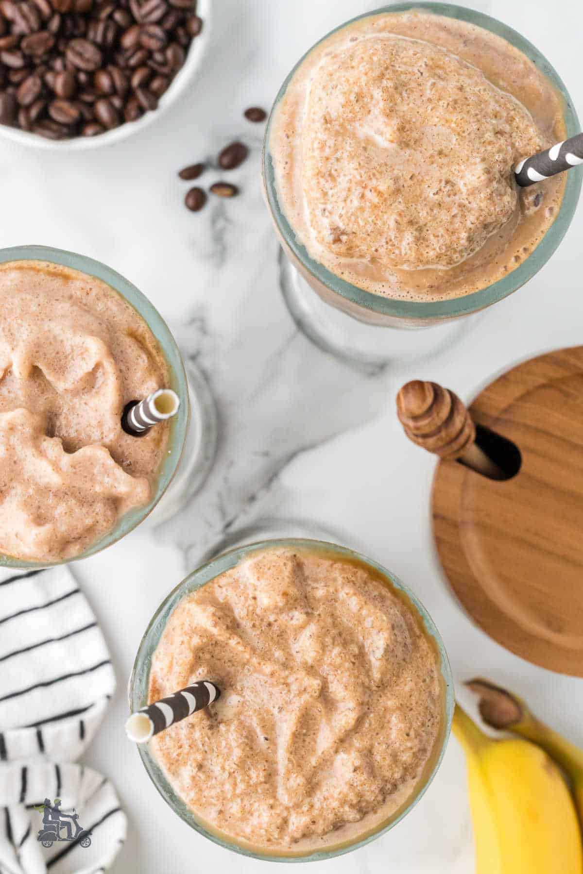 Overhead view of three parfait glasses filled with the banana espresso smoothie recipe. 