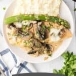 A Pinterest image shows a delicious chicken Madeira dinner. The plate features tender chicken topped with rich wine sauce, fresh asparagus, and creamy mashed potatoes.