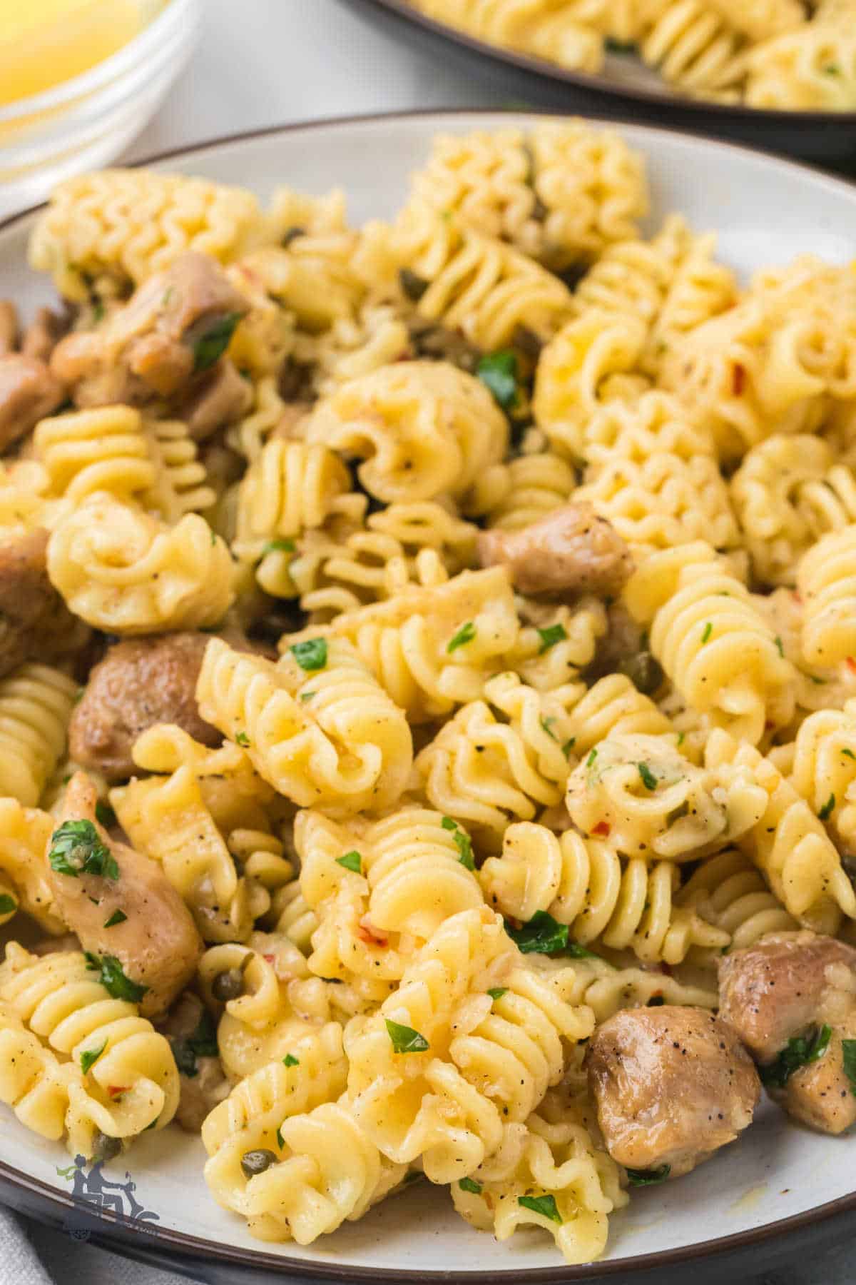 One-pan chicken piccata pasta dinner on a plate, ready to serve. 