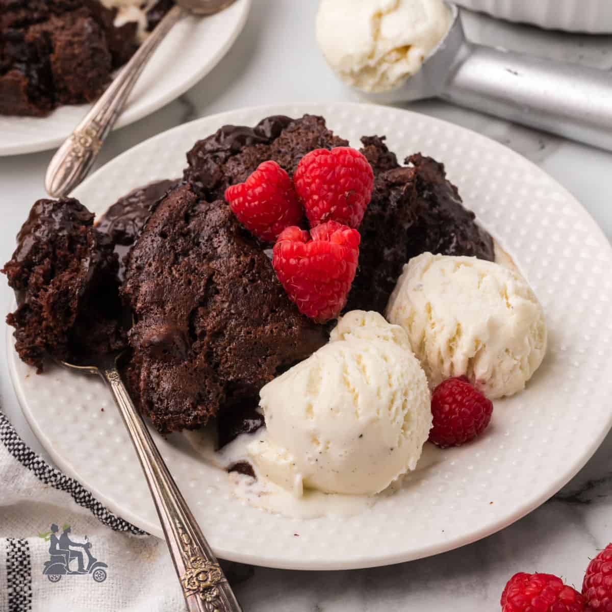 Chocolate Pudding cake laced with amaretto and served with fresh raspberries and vanilla ice cream.