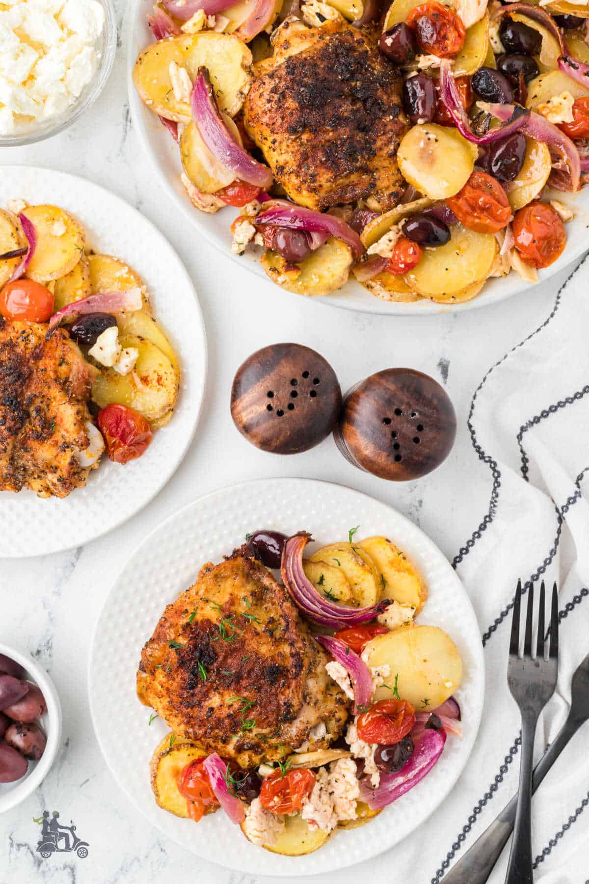 Mediterranean flavors in one pan feature chicken thighs, potatoes, herbs, and red bell peppers. 
