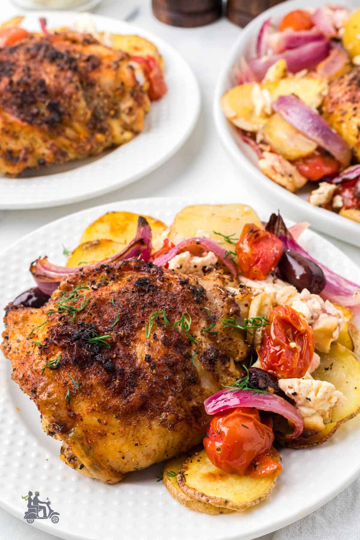 Greek Chicken Thighs Sheet Pan Dinner with garlic sauce, vegetables, and Feta cheese. 