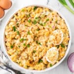 Jalapeño relish deviled egg pasta salad with bacon bits and sprinkled with sliced green onions.