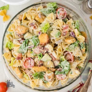 A Glass bowl filled with a BLT pasta salad dressed with Ranch Dressing.