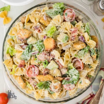 A Glass bowl filled with a BLT pasta salad dressed with Ranch Dressing.