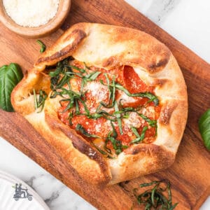 Pizza Dough stuffed with Brie cheese and topped with pizza sauce, pepperoni, and two cheeses.